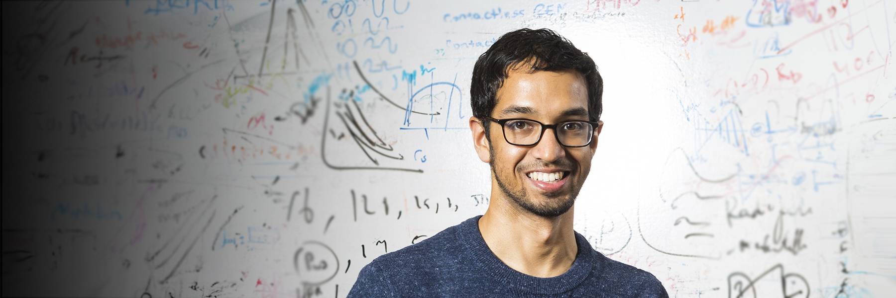 New AI model keeps up with the latest scientific research Science and math symbols hand drawn in white on a black background