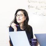 Su-In Lee sitting behind a laptop looking thoughtful