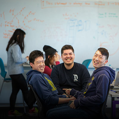 Undergraduate students sitting together at a table.