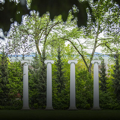 A leaf framed photo of the four columns at Sylvan Grove