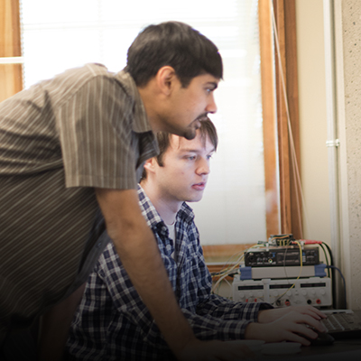 Professor Shwetak Patel and student Eric Whitmire view a computer screen