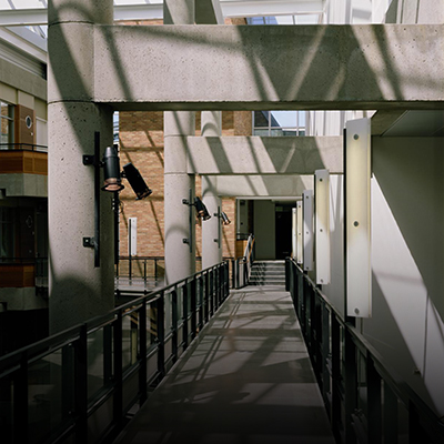 The Allen School catwalk with the light shining through the windows and producing long shadows.