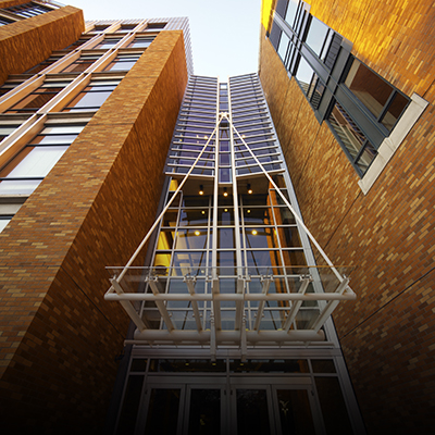 Looking up at metal and glass entrance to Allen Center