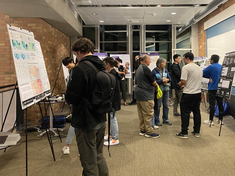 Research Showcase participants viewing student research posters.