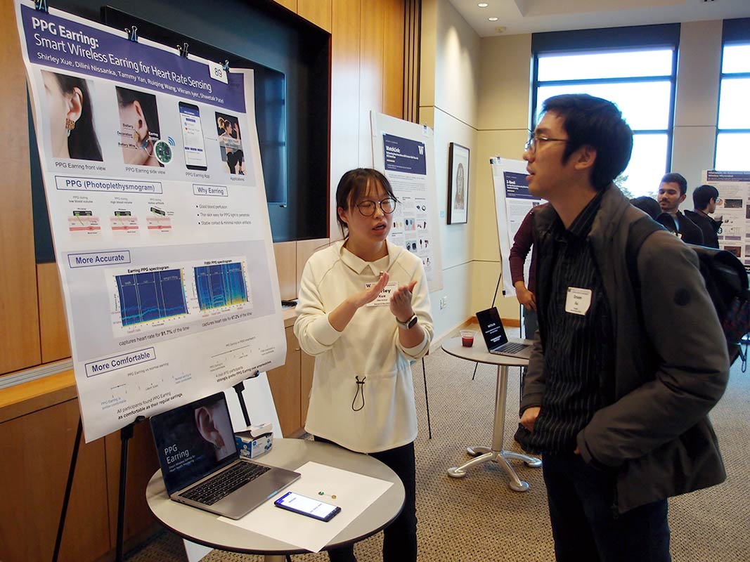 Research Showcase poster session photo showing interaction between researcher and an attendee.