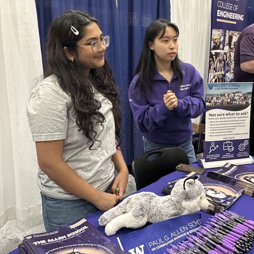 Two Student Recruitment Representatives chat with prospective students at the Seattle National College Fair