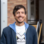 Portrait of Jon Froehlich wearing a shirt with the Makeability Lab logo on it.