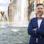 Noah A. Smith poses in front of the Drumheller Fountain at the University of Washington.