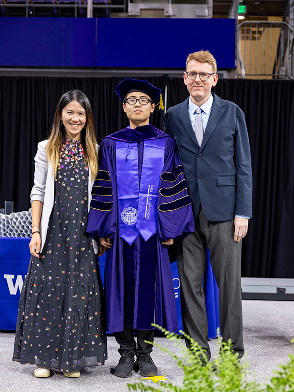 At his graduation, Chenzhi Zhu (center) poses with his advisors Rachel Lin (left) and Stefano Tessaro (right).