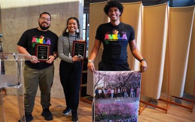 Vicente Arroyos, Leilani Battle and Kyle Johnson accept the SIGCHI Special Recognition for their work with AVELA. Kyle holds a poster of a group photo of all other AVELA members.