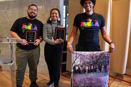 Vicente Arroyos, Leilani Battle and Kyle Johnson accept the SIGCHI Special Recognition for their work with AVELA. Kyle holds a poster of a group photo of all other AVELA members.