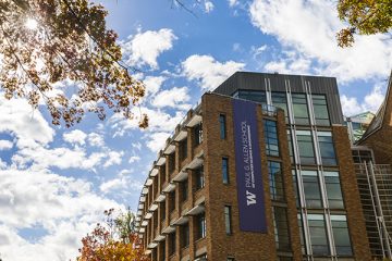 View of the Paul G. Allen School of Computer Science & Engineering building surrounded by autumnal trees.