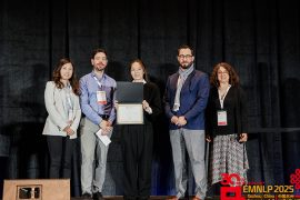 Hao Xu (center) accepts the EMNLP Best Paper Award among members of the conference program chairs.