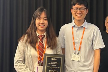 Er-Cheng Tang and Mi-Ying (Miryam) Huang hold the plaque they received for the Machtey Award for Best Student Paper.