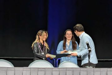 At NeurIPS 2025, Yejin Choi and Liwei Jiang accept the Best Paper Award from the oral session chair.