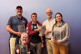 Members of the "Freedom to Roam" research team hold their SIGACCESS ASSETS Paper Impact Award.