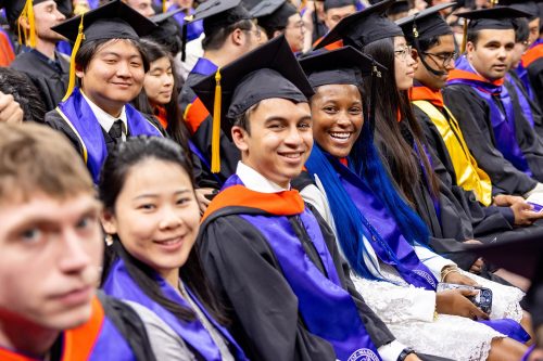 Professional Master's students, wearing the caps and gowns, attending the CSE Graduation Ceremony