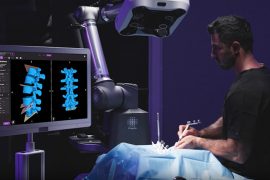 A surgeon performing spinal procedure while viewing a 3D image of a section of spine on a monitor