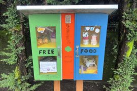 A brightly painted hutch that functions as a micropantry containing free food for the community