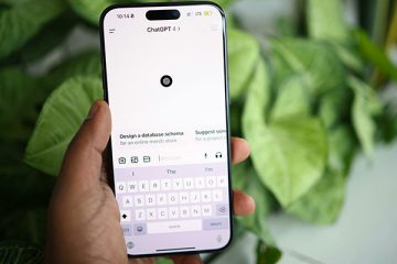 Hand holding a smartphone with ChatGPT interface onscreen