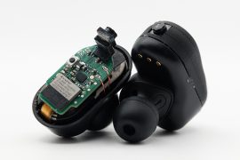 Closeup of a pair of earbuds fitted with tiny cameras