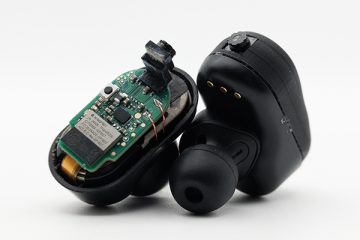 Closeup of a pair of earbuds fitted with tiny cameras