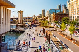People enjoy the pedestrian improvements adjacent to the Seattle waterfront that include separate sidewalk, bike lane and car lanes