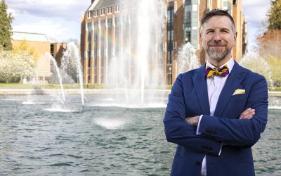 Noah A. Smith poses in front of the Drumheller Fountain at the University of Washington.