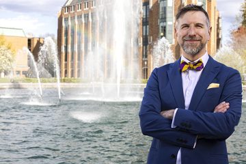 Noah A. Smith poses in front of the Drumheller Fountain at the University of Washington.