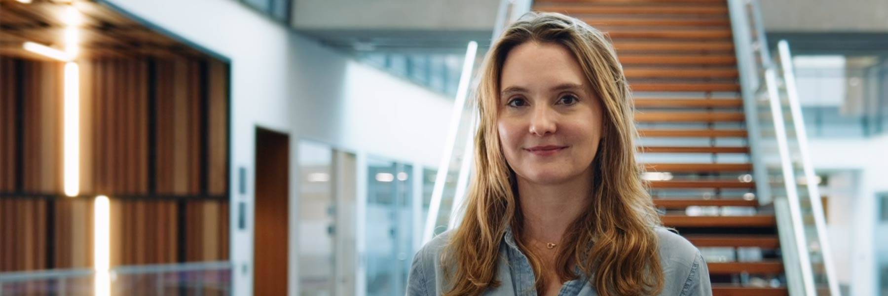 Magnifying glass resting on a laptop keyboard reflecting the light of the keys and screen