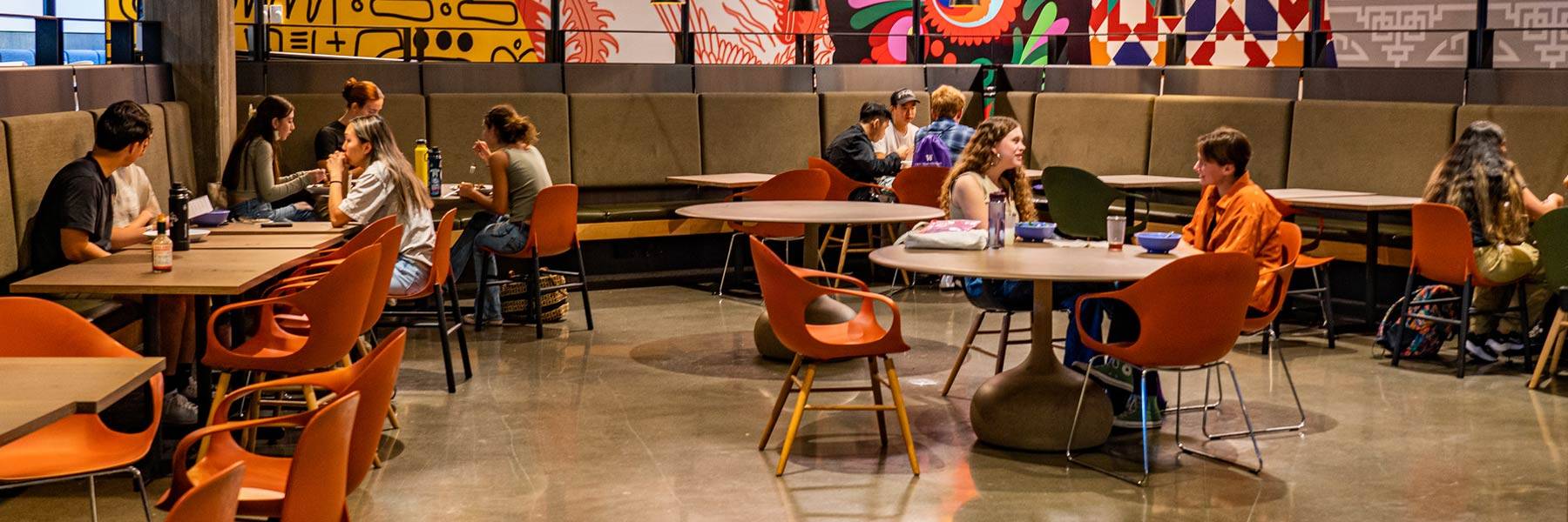 Magnifying glass resting on a laptop keyboard reflecting the light of the keys and screen